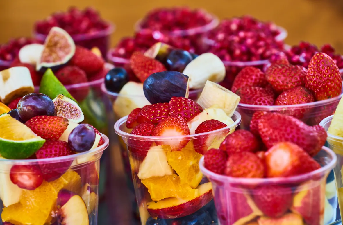 Colorful fruit cups filled with fresh berries, figs, and citrus, a vibrant take on the creamy cocoa fruit cup concept.