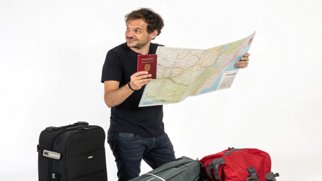 A traveler standing with luggage and a map, considering what to put in a travel personal website for their next destination.