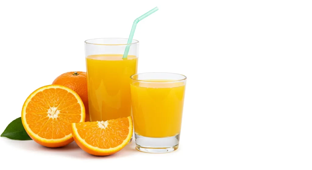 Fresh squeezed orange juice with slices of orange and a straw.